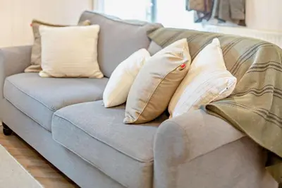 a gray couch with four pillows on it at 2 Bed in St. Columb oc-h29936 in Saint Columb Major