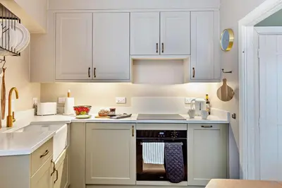 a kitchen with white cabinets and an oven at 2 Bed in St. Columb oc-h29936 in Saint Columb Major