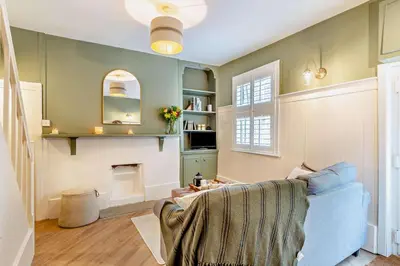 a living room with a blue couch and a fireplace at 2 Bed in St. Columb oc-h29936 in Saint Columb Major