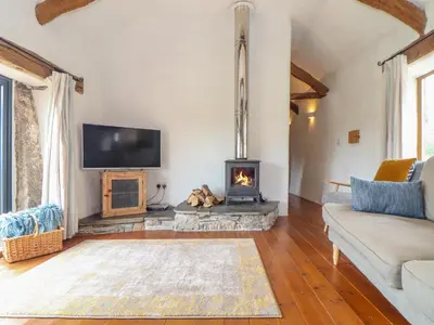 a living room with a fireplace and a tv at Skiber Long in Callington