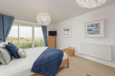 a bedroom with a bed and a large window at Host & Stay - Sunset in Newquay