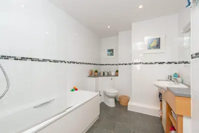 a bathroom with a tub and a toilet and a sink at Host & Stay - Sunset in Newquay