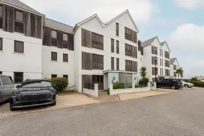 a row of buildings with cars parked in a parking lot at Host & Stay - Sunset in Newquay