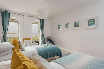a bedroom with two beds and a window at Host & Stay - Sunset in Newquay