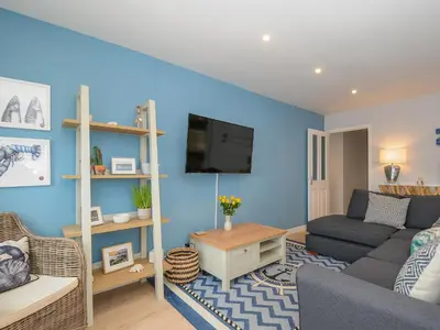 a living room with a couch and a tv at Coastal Haven in Bude
