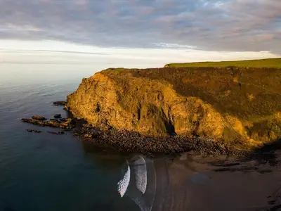 an aerial view of a cliff in the ocean at Coastal Haven in Bude