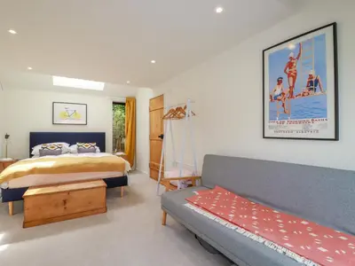 a bedroom with a bed and a couch at The Old Watermill in Bodmin