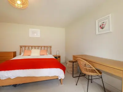 a bedroom with a large bed and a desk at The Old Watermill in Bodmin
