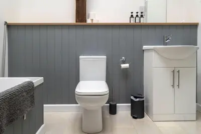 a bathroom with a white toilet and a sink at Great Cornish Coastal Retreat in Par