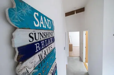 a stack of street signs on a wall at Great Cornish Coastal Retreat in Par