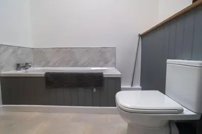 a bathroom with a white toilet and a sink at Great Cornish Coastal Retreat in Par