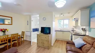 a kitchen and living room with a couch and a table at 06 Strawberry Hill, Tolroy Manor in Hayle