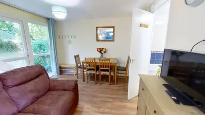 a living room with a couch and a table at 06 Strawberry Hill, Tolroy Manor in Hayle
