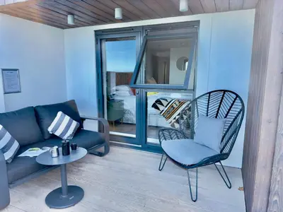 a living room with a couch and a chair at Bayvista in St Ives