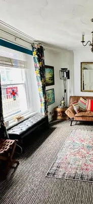 a living room with a couch and a window at Seaway Beach House Looe Beach in Looe