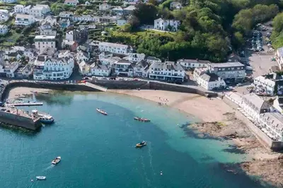 an aerial view of a beach with boats in the water at The Cuckoo's Nest - A Romantic & Peaceful Hideaway in Kenwyn