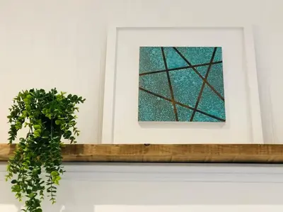 a plant sitting on a ledge next to a painting at The Cuckoo's Retreat - Luxurious home with private garden & jacuzzi in Kenwyn