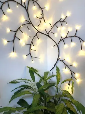 a christmas tree with lights on a wall at The Cuckoo's Retreat - Luxurious home with private garden & jacuzzi in Kenwyn