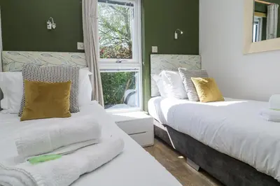 a bedroom with two beds and a window at Bay View in Redruth