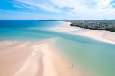 an aerial view of a beach with sand and water at Cosy Cornish Hideaway Hayle in Hayle