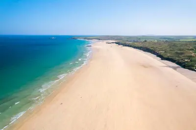 an aerial view of a sandy beach next to the ocean at Cosy Cornish Hideaway Hayle in Hayle