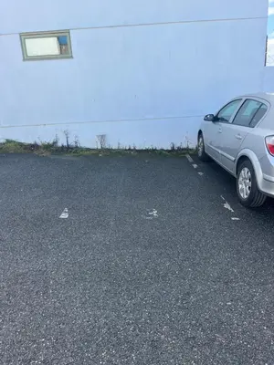 a car parked in a parking lot next to a building at Cosy Cornish Hideaway Hayle in Hayle