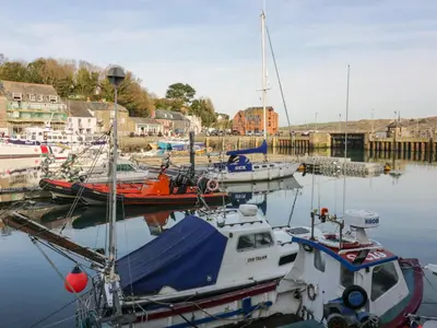 a group of boats are docked in a harbor at Gwanda in Padstow