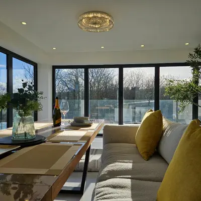a living room with a couch and a table at Luxury Seaview, Modern, 6 beds in Mevagissey