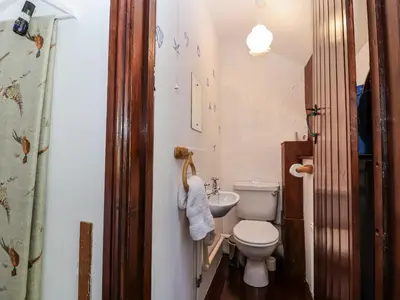 a small bathroom with a toilet and a sink at The Dairy in Liskeard