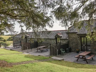 a building with picnic tables in front of it at The Dairy in Liskeard