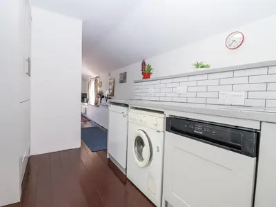 a laundry room with a washer and dryer at The Byre in Liskeard