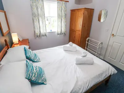 a bedroom with a bed with two towels on it at Chy Lowena in Falmouth