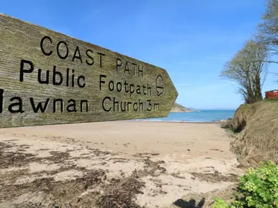 a sign for the coast path at the beach at Chy Lowena in Falmouth