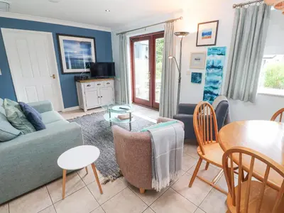 a living room with a couch and a table at Chy Lowena in Falmouth