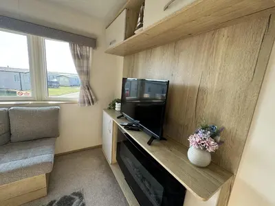 a small living room with a tv and a couch at Perranporth Coastal Retreat- Sleeps8 in Perranporth