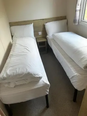 two beds in a room with white sheets at Perranporth Coastal Retreat- Sleeps8 in Perranporth