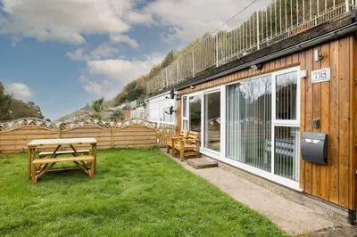 a patio with a picnic table and a building at 118 Sandyfeet Retreat in Saint Martin