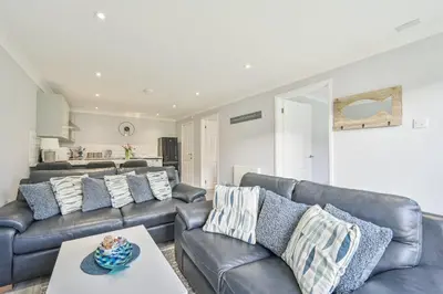 a living room with leather couches and a table at 118 Sandyfeet Retreat in Saint Martin