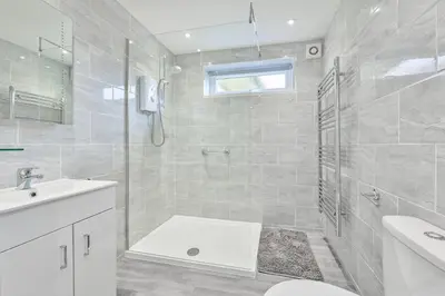 a bathroom with a shower and a toilet and a sink at 118 Sandyfeet Retreat in Saint Martin