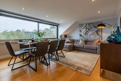 a dining room and living room with a table and chairs at 4 Bed in Carbis Bay oc-m30075 in Carbis Bay