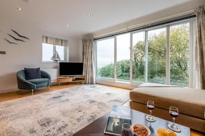 a living room with a bed and a large window at 4 Bed in Carbis Bay oc-m30075 in Carbis Bay