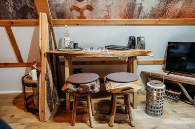 a room with a table with stools and a keyboard at Wild Wren - A Nordic Getaway in Callington