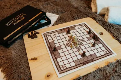 a board game with insects on it next to a book at Wild Wren - A Nordic Getaway in Callington