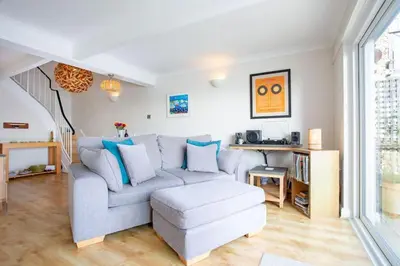 a living room with a couch and a chair at Janes Court, Packet Quays in Falmouth