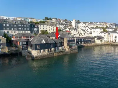 a group of buildings next to a body of water at Janes Court, Packet Quays in Falmouth