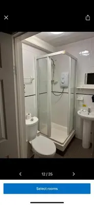a bathroom with a shower and a toilet and a sink at Kings head in Chacewater