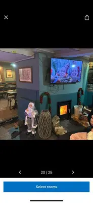 a living room with a tv and a fireplace at Kings head in Chacewater