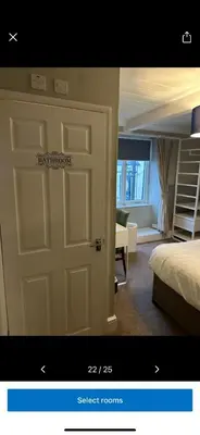 a room with a door and a bedroom with a bed at Kings head in Chacewater