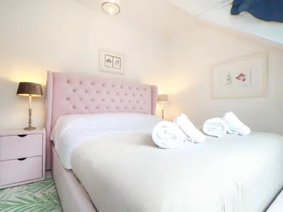 a bedroom with two beds with towels on them at Mor Kernow in St Ives