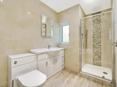 a bathroom with a toilet and a sink and a shower at Fairwinds in Portreath